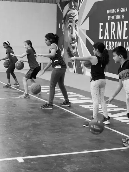 A black and white shot capturing the focus of our young players during a fundamental drill. The journey to success starts here.