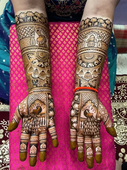 This design showcases a perfect balance of positive and negative space. The prominent peacocks and elephants are highlighted by the surrounding detailed patterns.
