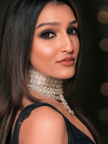 A close-up of the smoky eye makeup that complements the modern black saree look. The overall vibe is chic and sophisticated.