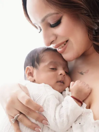 There is no safer place than in a mother's arms. This close-up shot captures the warmth and security of a mother's embrace.