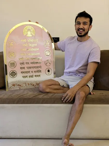 Here I am with the pink ocean-themed Navkar Mantra frame. This 24 by 30-inch piece is a great example of how I can combine different themes to create something truly unique and personalized.
