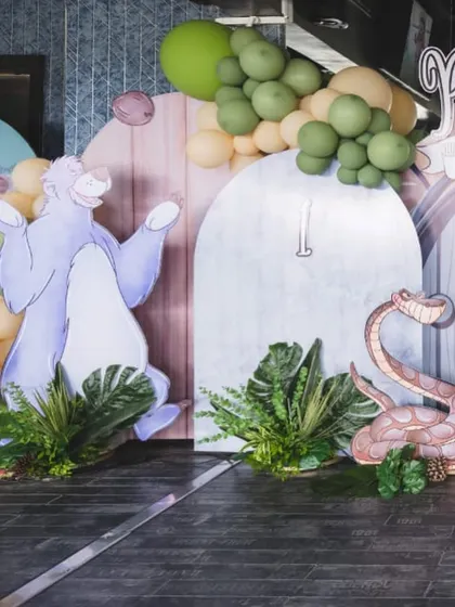Baloo and Kaa from The Jungle Book are featured as large cutouts against a whimsical backdrop, bringing the classic story to life for a first birthday party.