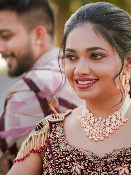 A bride looking radiant in a delicate Kundan choker with pearls. It's a perfect choice for an engagement or pre-wedding event where you want to look elegant without being overly heavy.