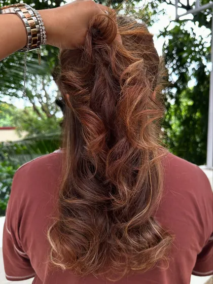 Rich, warm tones styled into a high ponytail to showcase the multi-level layers.