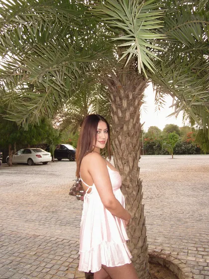 A light pink backless babydoll dress, perfect for a warm day at a farmhouse or a picnic.