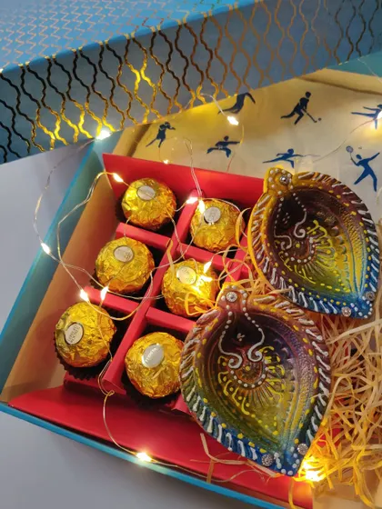 My Diwali gift hampers are perfect for corporate or personal gifting. These boxes are filled with treats, hand-painted diyas, and fairy lights to bring a festive glow.