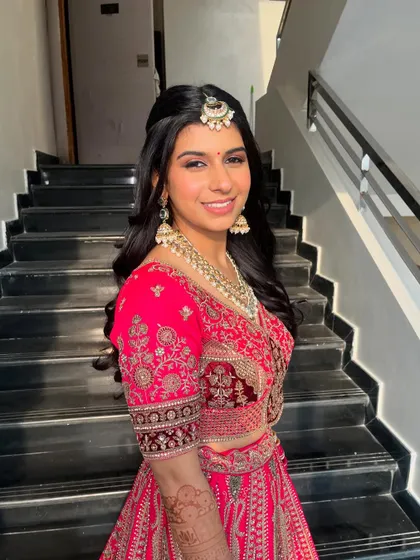 A close-up of the happy bride. The makeup is soft and natural, and the loose waves in her hair add a touch of romantic elegance.