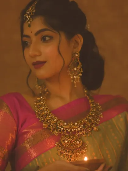 A festive portrait for Deepavali, with the focus on a gorgeous piece of temple jewelry. The warm light from the diya illuminates the intricate craftsmanship of the necklace.