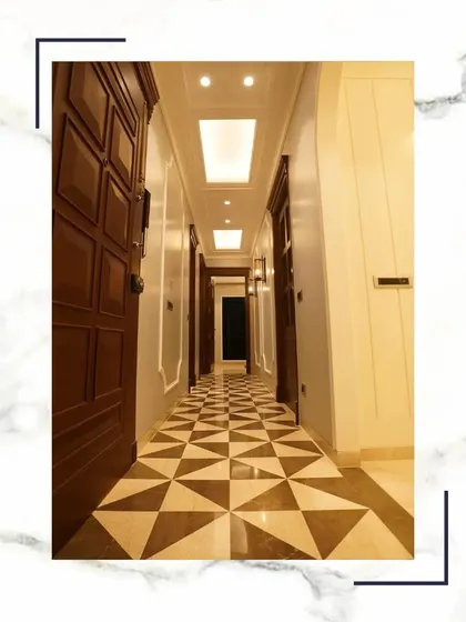 This grand hallway with its geometric Italian marble flooring and solid wooden doors is designed to impress. It’s a perfect example of how we use high-quality materials to create a luxurious feel.