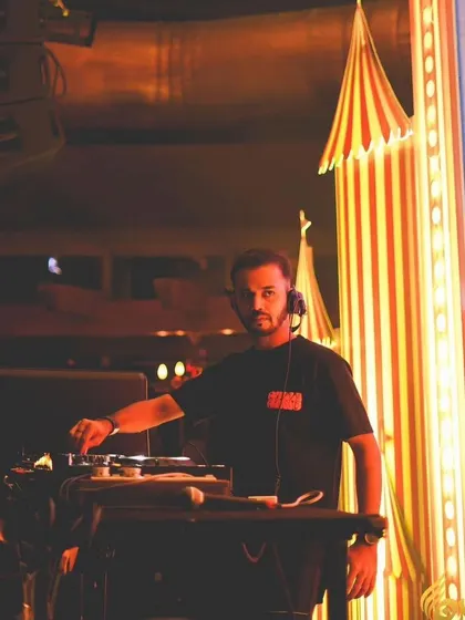Performing at Opa Bar, with its unique circus-themed decor in the background.