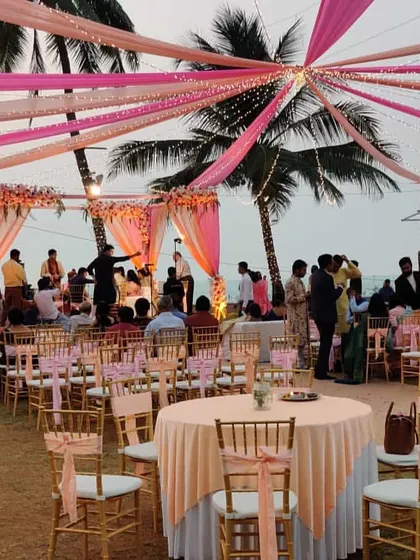 This photo shows the lively atmosphere of a beach wedding we decorated. The combination of the beautiful mandap, elegant guest seating, and the happy crowd is what makes our work so rewarding.