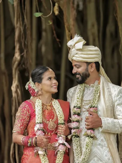 A beautiful candid shot of a couple sharing a look of love, framed by the roots of an ancient banyan tree.