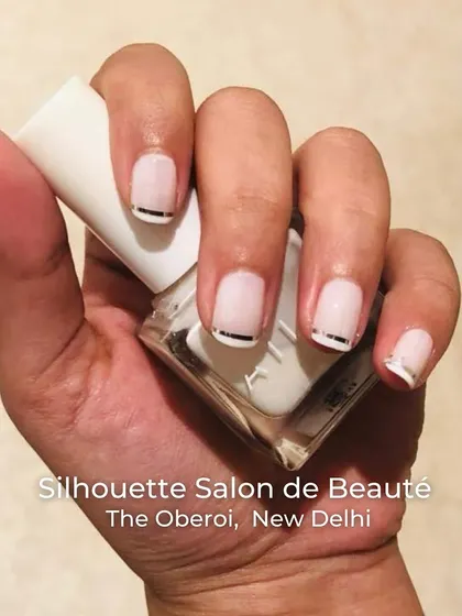 A chic and modern take on the nude nail. This design features a soft, semi-sheer base with a clean, metallic silver line at the cuticle, adding a subtle yet sophisticated detail to a classic look.