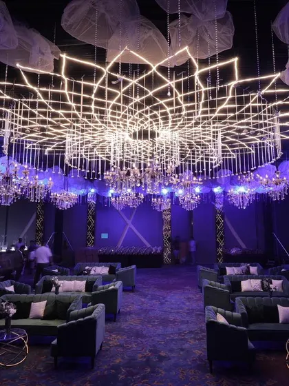 A full view of the lotus-inspired geometric lighting structure, showing how it transforms the entire reception hall and creates a spectacular, modern ambiance for a large-scale event.