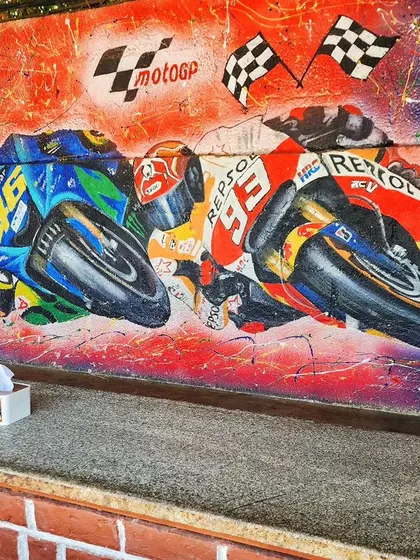 The full view of the MotoGP mural, showing how it energizes the seating area at Burnout Café.