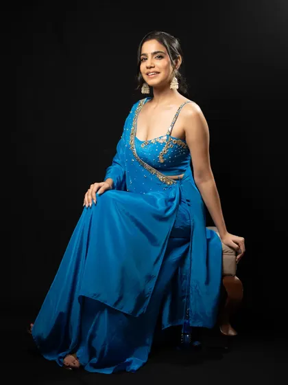 A seated portrait in the blue outfit, exuding grace and charm.