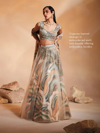 The Ivy Lehenga Set, showcasing a unique blend of soft pastel prints and shimmering hand-embroidery. The organza layered lehenga creates a light, ethereal silhouette, ideal for daytime celebrations and evening parties.