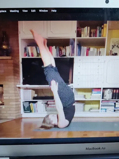 Here, a student practices an inversion during our one-on-one class. It's a beautiful example of discipline and trust. We've never met in person, but it's a wonderful feeling to guide her practice and see her progress.