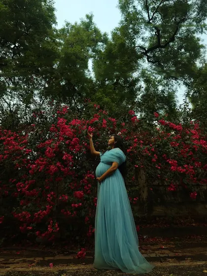 The full length of the blue gown is showcased here, emphasizing its flowing design which is perfect for capturing beautiful moments in nature.