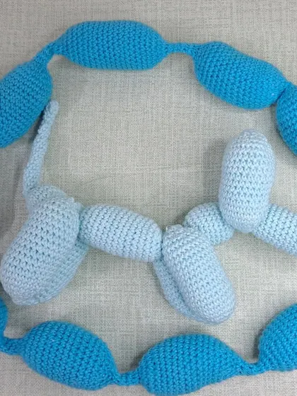 My crochet balloon dogs are a fun and modern addition to any nursery decor. Here are two, one in light blue and one in a darker blue.