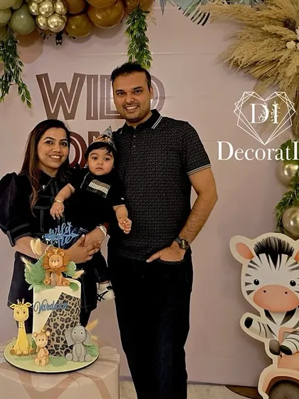 A beautiful family photo in front of the "Wild One" backdrop, capturing a cherished memory.