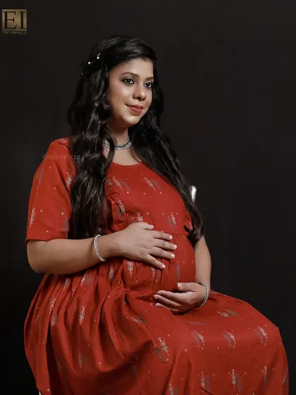 A comfortable yet stylish printed red dress, perfect for a relaxed and happy studio portrait.