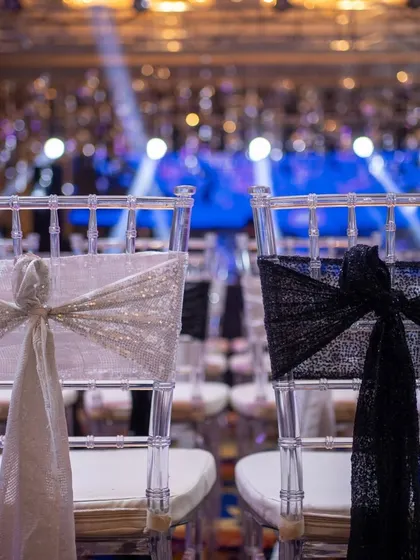 Detail of the guest seating for the sangeet. Even the chair ties, with black and silver sequins, are chosen to match the glamorous disco theme of the night.