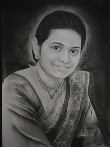 A beautiful charcoal portrait of a woman in a saree, with a soft halo of light around her. This reverse drawing technique creates a stunning effect.