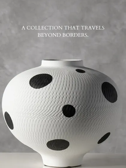 Inspired by global textiles, this black and white polka dot vase features a subtle, incised texture that invites a closer look. It is a playful yet sophisticated piece that travels effortlessly between different decor styles.