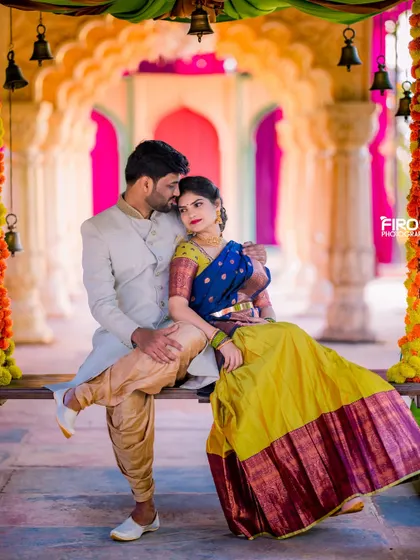 A tender moment on a decorated swing, with the couple in vibrant traditional outfits. The colorful setup and their loving gaze make this a perfect pre-wedding shot.
