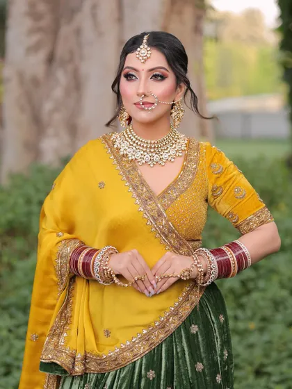 A regal pose from our beautiful bride. The makeup focuses on sharp, defined eyes and a flawless complexion, allowing her traditional jewelry and outfit to take center stage.