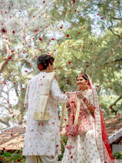 A shower of petals rains down on the couple during the 'jaimala' or garland exchange ceremony. It's a moment of pure celebration that we love to make visually spectacular.