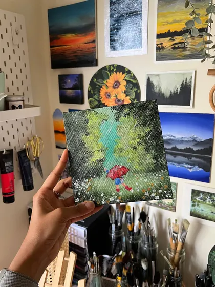 Holding up the finished rainy day painting in my studio. It’s a happy little piece that always makes me smile.