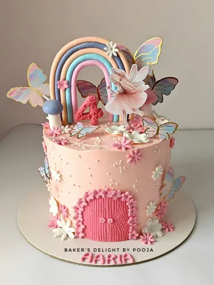 A whimsical fairy cake that's a true pastel dream. Designed for a 4th birthday, it features a beautiful rainbow, delicate butterflies, and a tiny fairy door, making it perfect for a magical celebration.