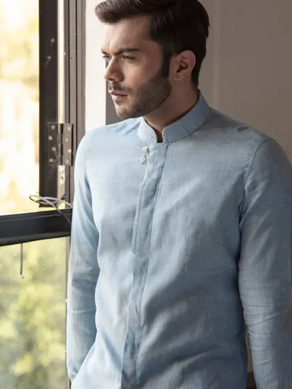 Embrace summer in style with a breezy pastel linen shirt. This light blue band-collar shirt is the perfect blend of comfort and elegance for summer days.