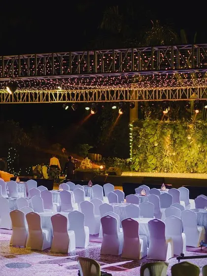 The full view of the sangeet stage, with a custom-printed dance floor, a beautifully draped dome, and our signature pink peacock props.