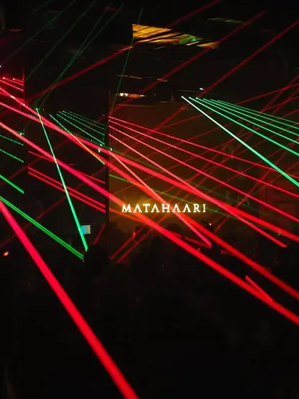 A full laser show in effect at Matahaari, with red and green beams creating a complex pattern.