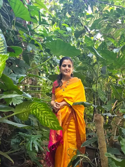 My wife in our urban jungle. Her love for plants and aesthetics has been instrumental in shaping our garden.