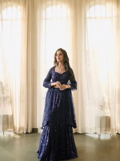 A three-quarter shot that focuses on the detailed sequin work and the flattering silhouette of the lehenga.