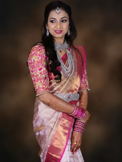This bride looks confident and happy in her reception attire. The makeup is subtle yet impactful, perfect for celebrating with family and friends.