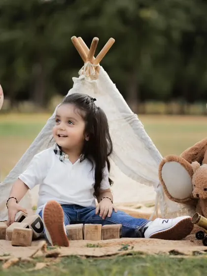 Our outdoor sessions are perfect for a relaxed, natural vibe. We set up this charming boho-themed teepee in a park, using natural light to capture this little one's curious and playful spirit.