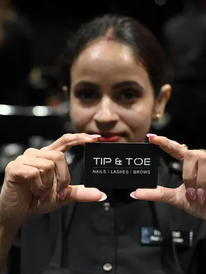 A smile from one of our expert technicians. Our team is the heart of the Tip & Toe experience.