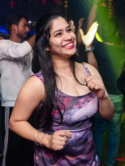 A happy face in the crowd, lit by the party lights. These are the moments that make a night special.
