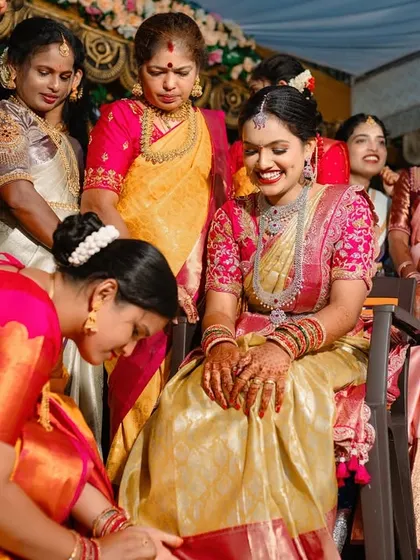 A beautiful candid moment of a bride surrounded by the important women in her life during a wedding ritual.