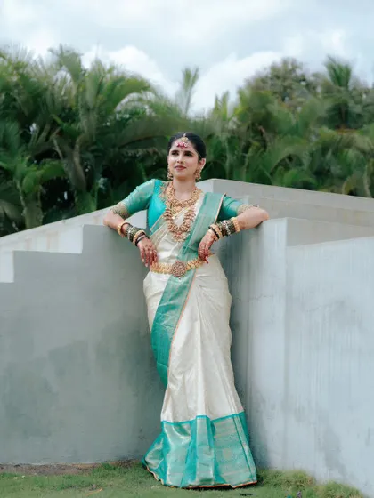 A full-length portrait of the bride in her stunning silk saree, showcasing her elegant posture and the beauty of her traditional wedding attire.