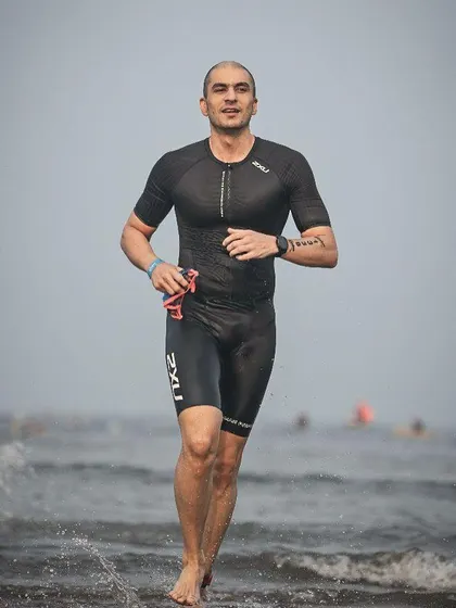 Emerging from the water after the swim portion of the Ironman 70.3. Our coaching covers all three disciplines of the triathlon.