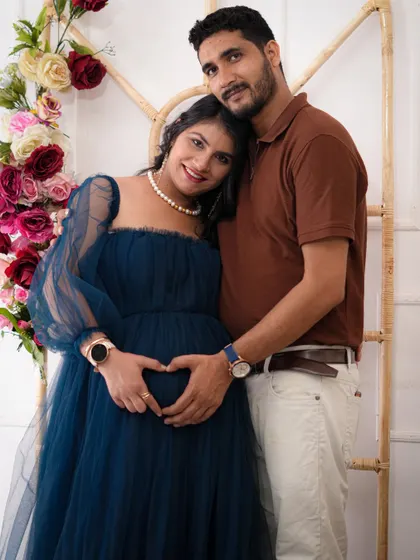 A classic couple pose, creating a heart shape over the baby bump. It’s a sweet and simple way to show the love and anticipation you share as you wait for your little one.