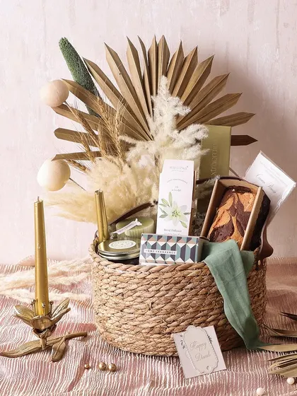 Our Cottage Charm Hamper is packed with comforting treats for Diwali, including cookies, a tea cake, chocolate truffles, and scented candles and sachets.