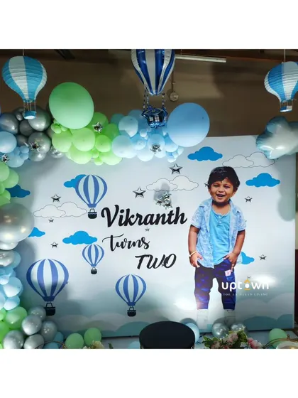 A hot air balloon theme for a second birthday, with a custom photo backdrop.