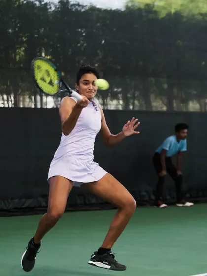 A dynamic backhand shot from one of our players, showcasing her powerful and fluid technique.